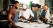 © CineLens2024/peopleimages.com - Cooking, class and chef teaching people in kitchen for knife skills, cutting technique and learning. Culinary course, students and mentor with lesson on onion preparation and education in hospitality