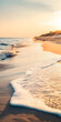 © CarlosEduardo - Nascer do sol sobre uma praia tranquila com ondas suaves.