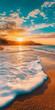 © CarlosEduardo - Nascer do sol sobre uma praia tranquila com ondas suaves.