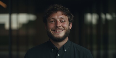 Cheerful Young Man Smiling in a Modern Indoor Setting