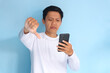 © Zulailar Studio - Young Asian man looking his mobile phone with sad expression