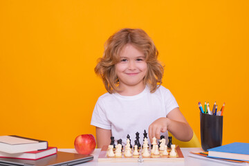 Aufkleber - Kid play chess on isolated studio background. Child think about chess game. Intelligent, smart and clever school kid pupil. Games for brain intelligence concept.