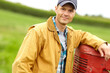© ReeseBuyout4/peopleimages.com - Farmer, man portrait and tractor for work in countryside for sustainable business. Farm, happy and agriculture for eco friendly and harvest in field with machine and vehicle for plant cultivation