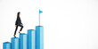 © Who is Danny - Businesswoman climbing blue graph bars towards a flag symbolizing achievement on a white background.