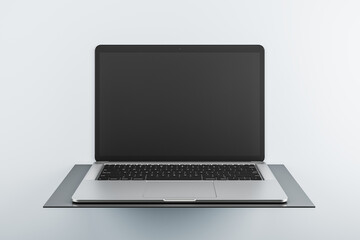 Poster - Front view on modern laptop blank black monitor with copyspace for your logo or text on dark stand isolated on light background. 3D rendering, mockup