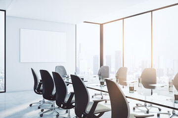 Wall Mural - Perspective view on sunny modern interior design meeting room with huge glass conference table, black chairs, blank white poster on light wall and city view from big windows. 3D rendering, mockup