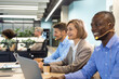 © ty - Attractive positive young businesspeople and colleagues in a call center office.