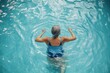 © Olsek - An active senior enjoys swimming in a serene blue pool water. This image captures joy in fitness and wellness for older adults. Perfect for health themes. Generative AI