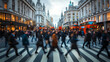 © paper later - A blurred image of a crowd of people crossing a street in London with double-decker buses, buildings, and storefronts in the background.