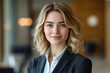 © Imagentive - Confident Blonde Businesswoman in Professional Suit Smiling Headshot
