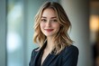 © Imagentive - Happy Businesswoman in Black Blazer with Long Hair and Bright Background