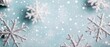 © pprothien - A serene winter scene showcasing delicate silver snowflakes on a soft blue background, creating a peaceful and festive atmosphere.