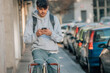 © carballo - student with mobile phone on the street walking with the vintage bicycle
