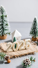 Poster - white wooden numbers 2025 with miniature pine trees a house