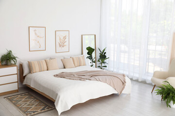 Poster - Large bed, houseplant and full-length mirror near window in room. Stylish bedroom interior