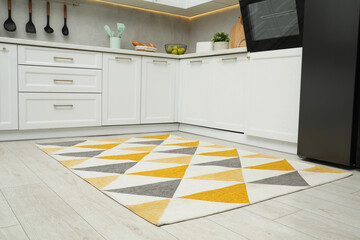 Sticker - Stylish soft rug on wooden floor in kitchen