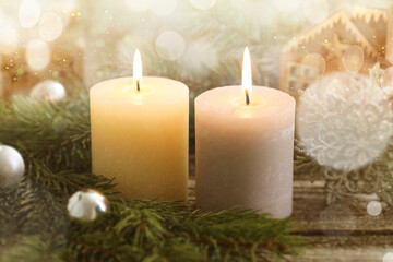 Canvas Print - Christmas composition with burning candles on wooden table, bokeh effect. Festive card