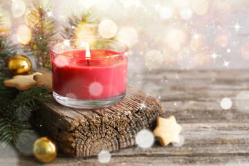 Poster - Christmas composition with burning candle on wooden table, bokeh effect. Festive card