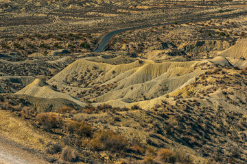 Wall Mural - Arid mountainous desolate landscape on a sunny day.