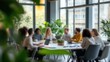 © CK Studio - This blurred image captures a group of professionals in a well-lit office, engaged in a collaborative discussion, with plants adding a refreshing, natural touch.