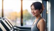 © ochikosan - ランニングマシンで運動する若い女性(Young woman exercising on a treadmill)