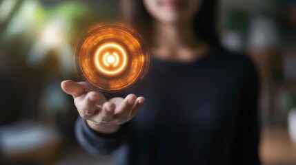 Poster - A woman's hand holds out a glowing orange circle with a smaller circle in the middle.