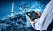 © panuwat - Smart industry 4.0 mangement control system concept.Hands holding tablet on blurred Chemical plant refinery industrial equipment as background