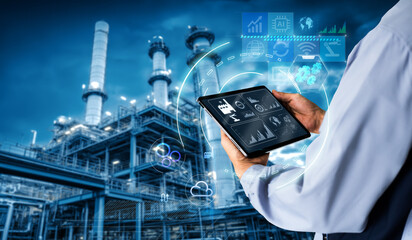 Smart industry 4.0 mangement control system concept.Hands holding tablet on blurred Chemical plant refinery industrial equipment as background