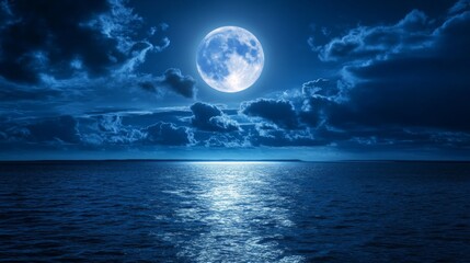 A full moon shines brightly in the night sky over a calm ocean with clouds passing by.