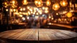 © 69 - A round wooden table in focus, with a blur of a lively pub and bokeh lights in the background.