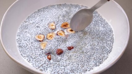 Canvas Print - Chia pudding with hazelnuts and maple syrup, white background. Healthy vegan breakfast.