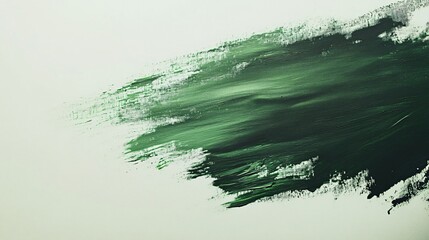 A smooth gradient of green emulsion paint smeared across a white canvas, with brushstrokes visible, isolated on a neutral backdrop