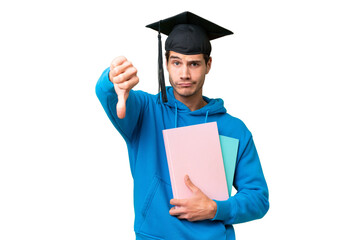 Wall Mural - Young university graduate man over isolated background showing thumb down with negative expression