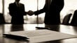© 69 Timeless  Studio  - A business meeting table with a handshake in the background and a contract and pen in the foreground, symbolizing a transaction.