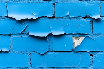 Cracked blue paint peeling off brick wall texture