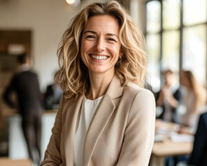 Wall Mural - A woman with a smile on her face is wearing a tan jacket and white shirt