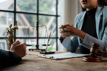 Wall Mural - Lawyer is explaining the details of a contract to her client during a meeting in her office