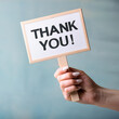 © Aurora - a woman hand holding a sign saying thank you, thank you message