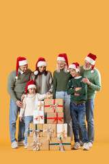 Canvas Print - Big family in Santa hats with Christmas presents on yellow background