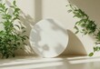 © ArtCookStudio - Circular white object on a table surrounded by green plants in natural light at midday