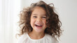 © Evon J - Happy Curly Haired Child Laughing Joyfully on White Background