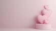 © Dumrongkait - Soft pink heart-shaped pillows are stacked on a round pedestal against a pastel backdrop, creating a warm, romantic atmosphere.