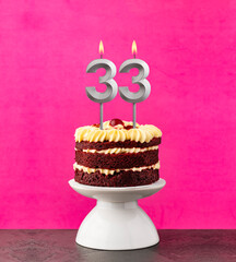 Red velvet cake - Birthday number 33 on a pink background.