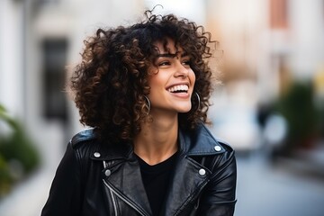 Portrait of a happy young woman with afro hairstyle smiling outdoors