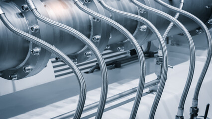 Poster - A series of pipes are shown in a silver color. The pipes are connected to each other and are of different sizes