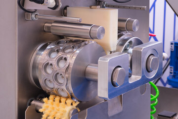 Poster - A machine with a white and silver color is shown. The machine is used for making doughnuts
