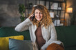 © Miljan Živković - woman with curly hair at home use mobile phone smartphone have a call