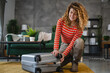 © Miljan Živković - One woman pack suitcase baggage prepare for vacation holiday
