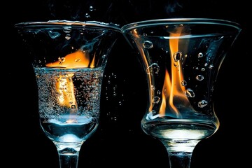 Two Glass Goblets Filled with Water, One with Fire Ignited Within