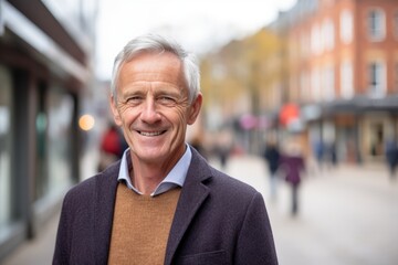 Poster - Portrait of a senior man smiling in the street. Looking at camera.